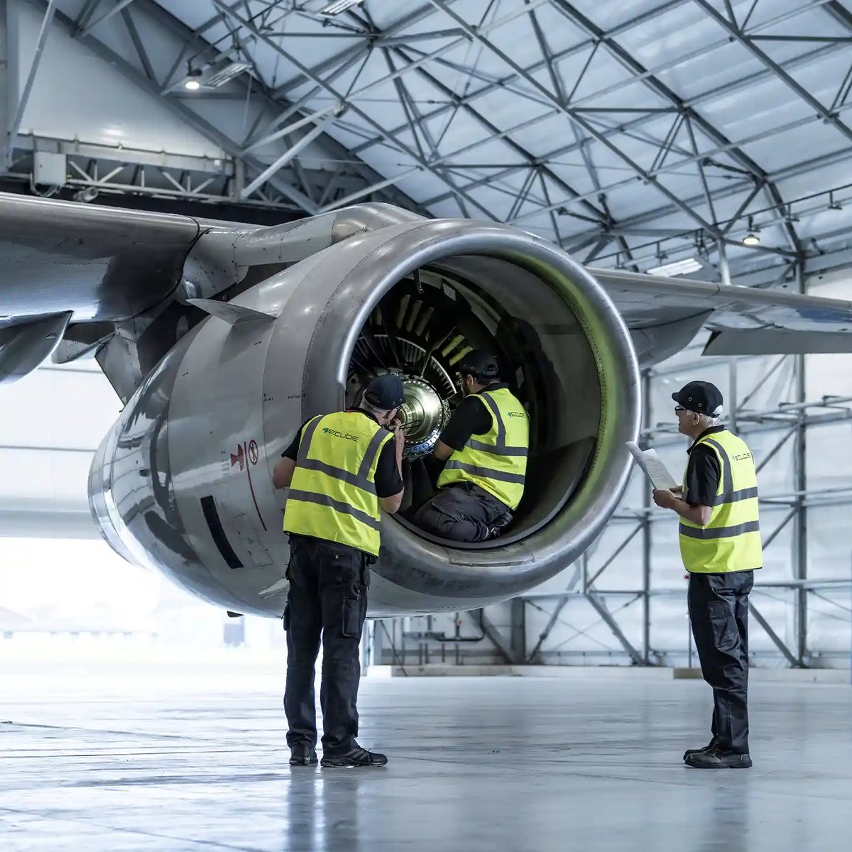 Engineers inspecting a turbofan engine